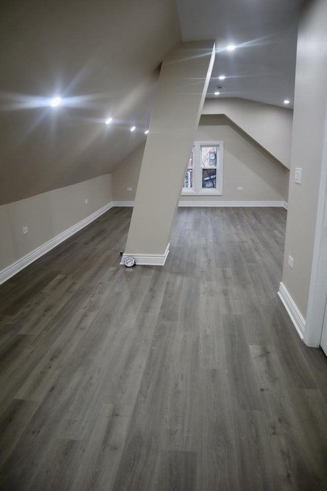 bonus room featuring dark hardwood / wood-style floors and vaulted ceiling