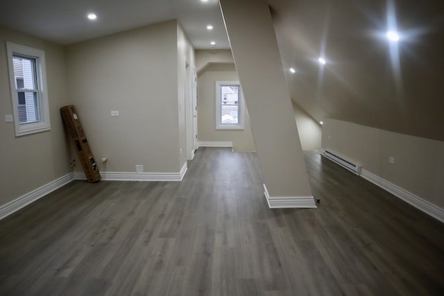 bonus room with a baseboard radiator and dark hardwood / wood-style floors