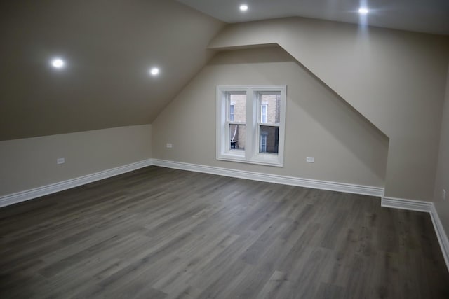 bonus room featuring dark hardwood / wood-style floors and lofted ceiling