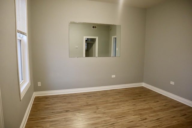 empty room with hardwood / wood-style flooring