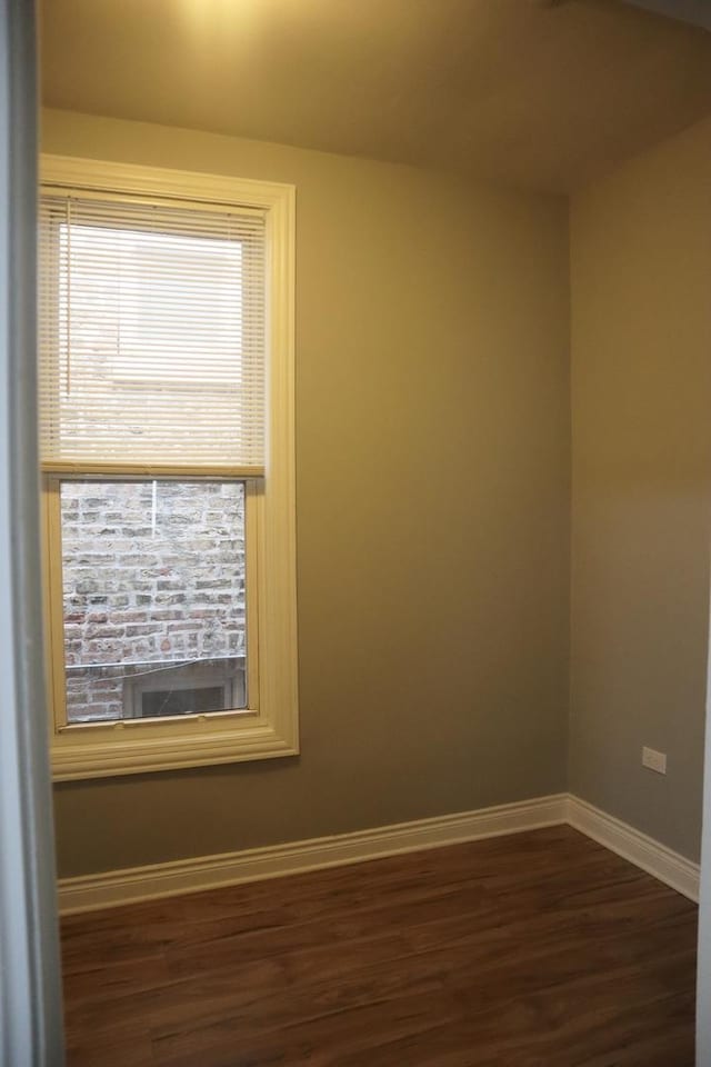 spare room with dark wood-type flooring