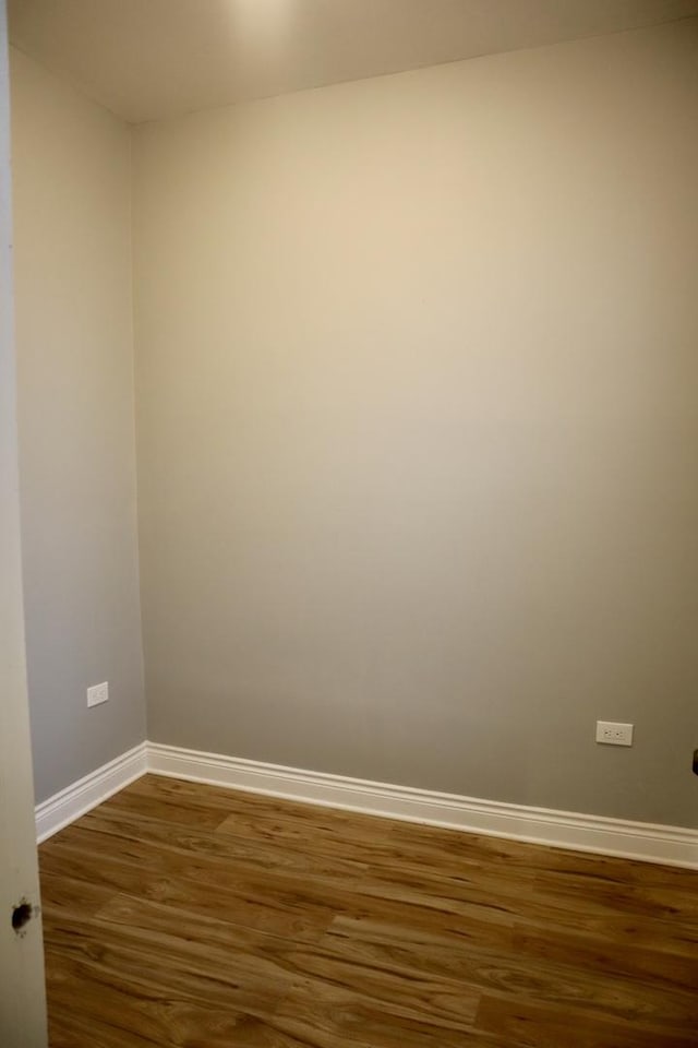 spare room with dark wood-type flooring