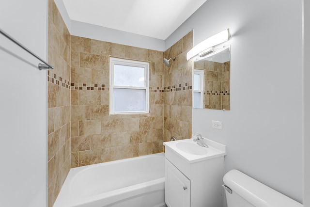 full bathroom with tiled shower / bath combo, toilet, and vanity