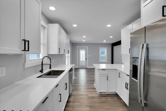 kitchen featuring dark wood-type flooring, white cabinetry, sink, and stainless steel appliances