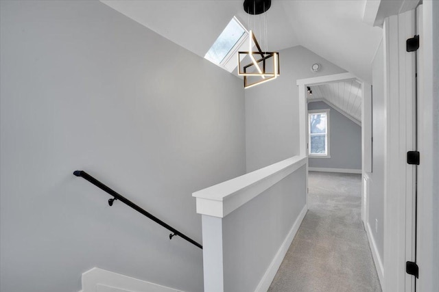 hallway featuring light carpet and vaulted ceiling