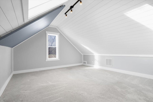 additional living space with lofted ceiling, carpet floors, and wooden ceiling