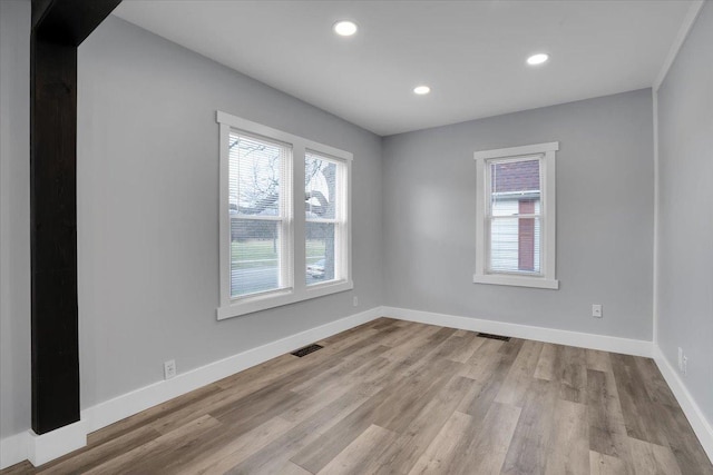 empty room featuring light hardwood / wood-style flooring and a healthy amount of sunlight