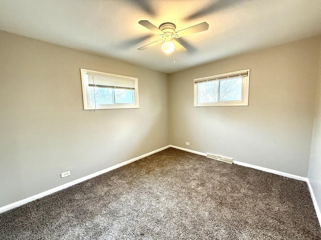 spare room with ceiling fan and carpet floors