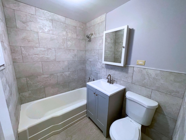 full bathroom with vanity, toilet, tile walls, and tiled shower / bath combo