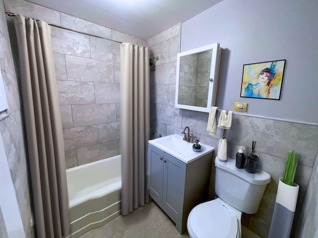 full bathroom with shower / bath combination with curtain, vanity, toilet, and tile walls