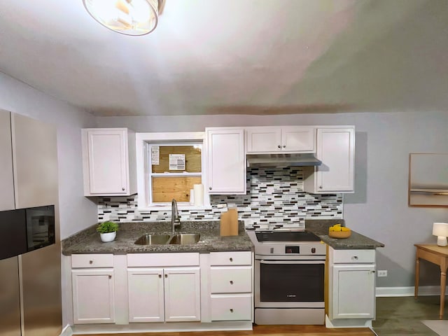 kitchen featuring white cabinets, range, tasteful backsplash, and sink