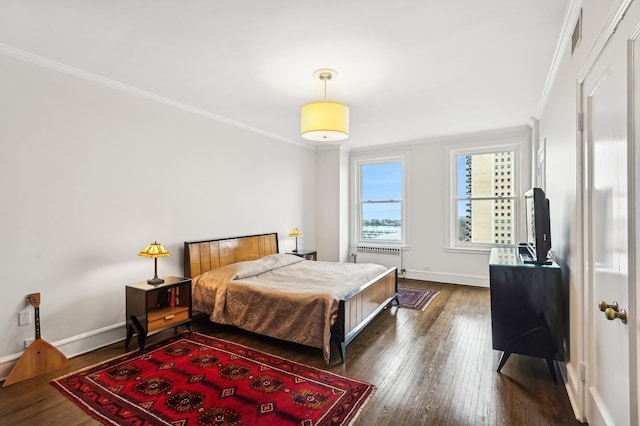 bedroom with radiator heating unit, ornamental molding, and dark hardwood / wood-style floors