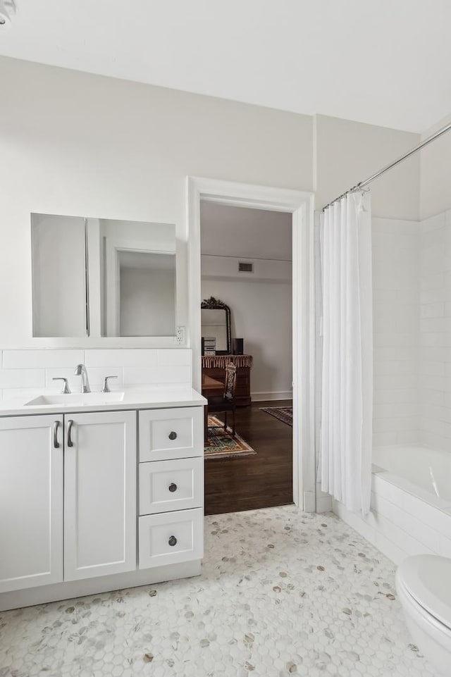 full bathroom with toilet, vanity, and shower / bath combination with curtain