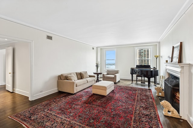 living room featuring dark hardwood / wood-style flooring and crown molding