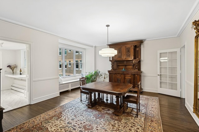 dining space featuring radiator, dark hardwood / wood-style flooring, baseboard heating, and ornamental molding