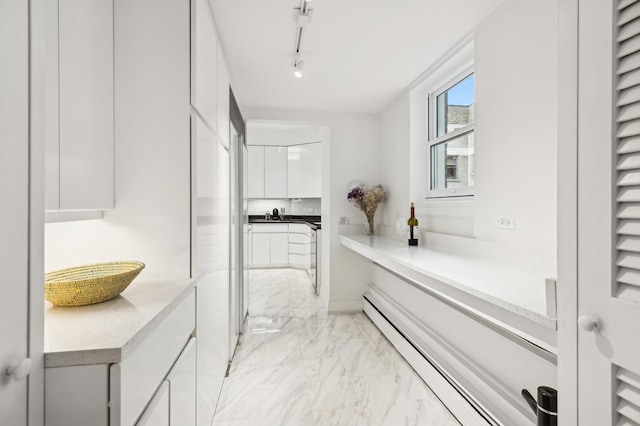 bathroom featuring sink and a baseboard heating unit