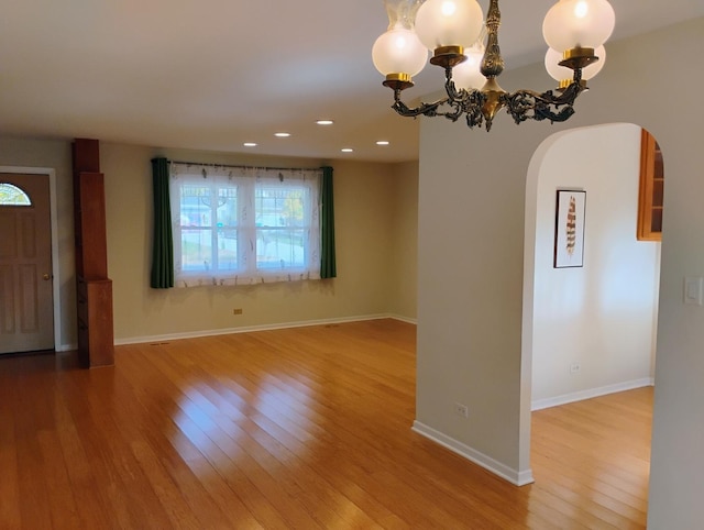 interior space with hardwood / wood-style floors and an inviting chandelier