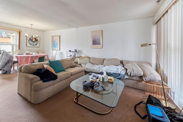 carpeted living room featuring an inviting chandelier