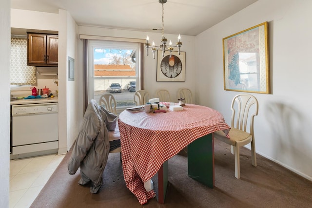 dining room featuring an inviting chandelier and light tile patterned floors