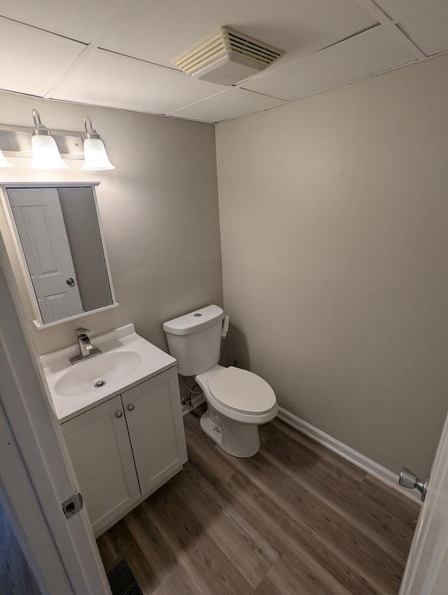 bathroom with vanity, wood-type flooring, and toilet