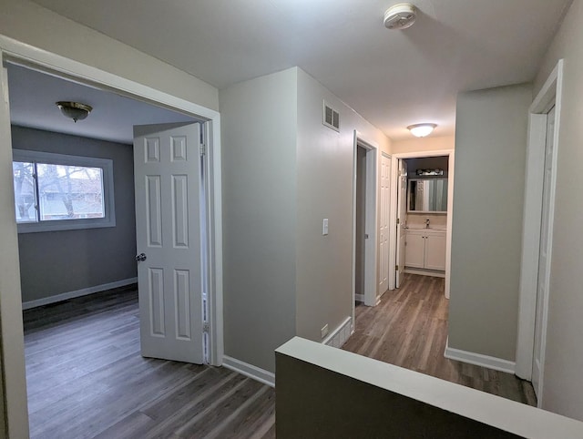 corridor featuring dark hardwood / wood-style flooring