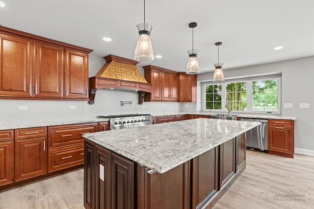 kitchen with premium range hood, a center island, decorative light fixtures, and dishwasher