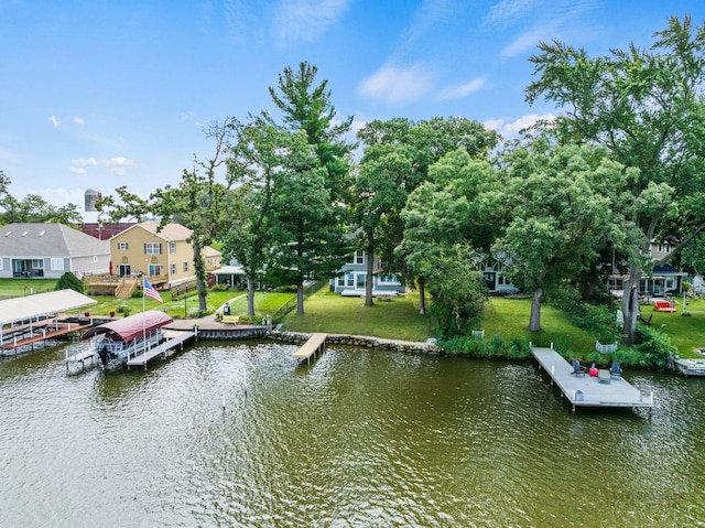 view of dock with a water view and a yard