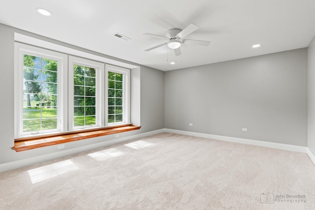 carpeted spare room with ceiling fan