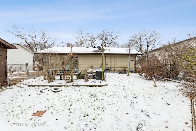 view of snow covered rear of property