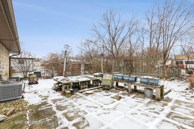 snow covered patio featuring central AC