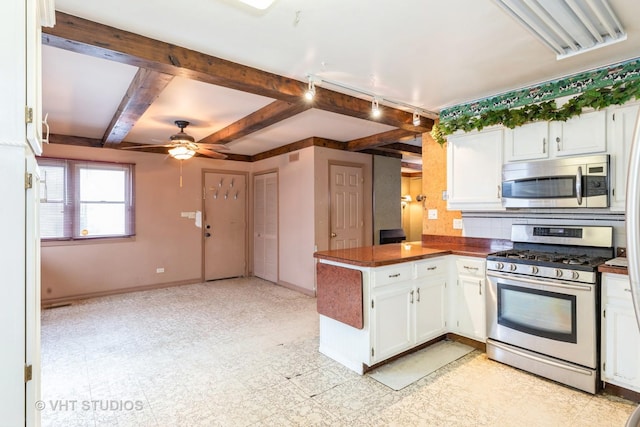 kitchen with ceiling fan, beamed ceiling, white cabinets, and stainless steel appliances