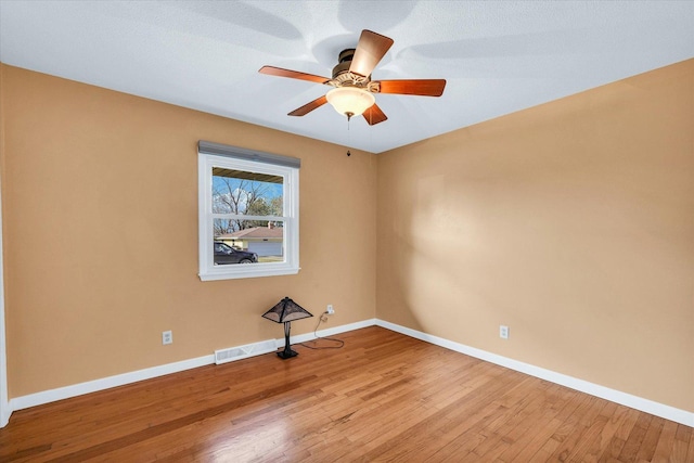 spare room featuring ceiling fan and light wood-type flooring