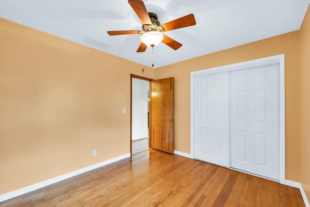 unfurnished bedroom with ceiling fan, light hardwood / wood-style flooring, and a closet