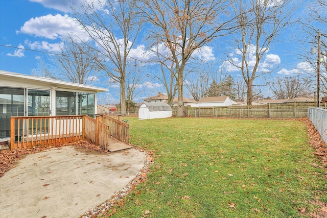 view of yard with a patio, a storage shed, and a sunroom