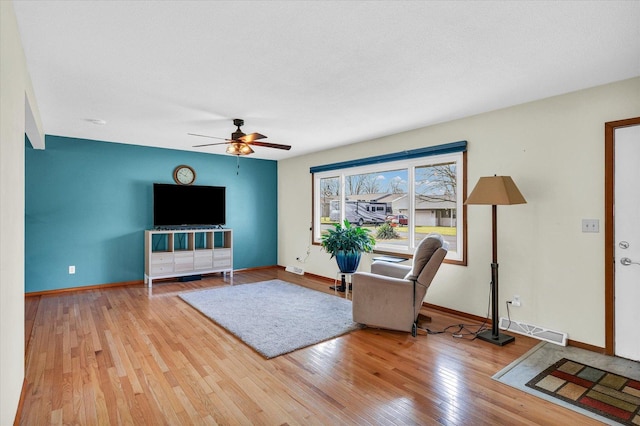 unfurnished living room featuring light wood-type flooring and ceiling fan