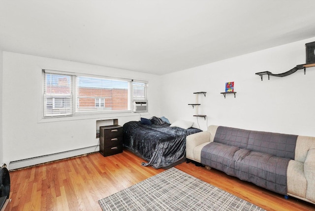 bedroom with hardwood / wood-style floors, cooling unit, and a baseboard heating unit