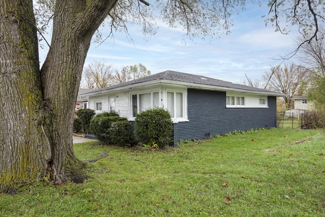 view of side of property with a lawn