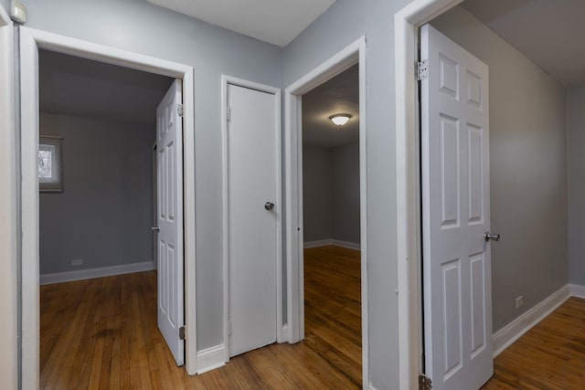 hallway with wood-type flooring