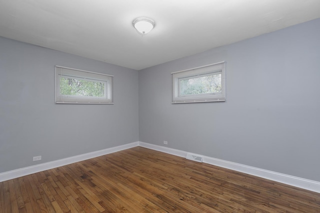 unfurnished room with plenty of natural light and hardwood / wood-style floors