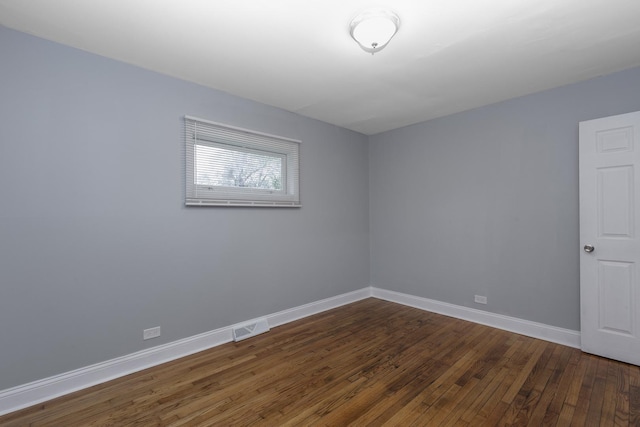 unfurnished room featuring dark wood-type flooring