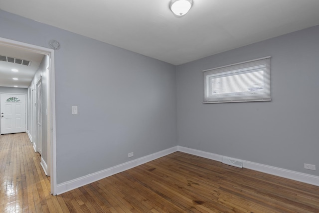 unfurnished room with dark wood-type flooring