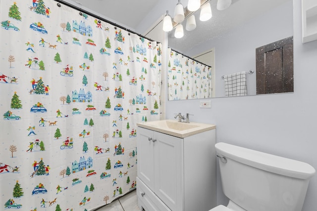 bathroom with tile patterned flooring, vanity, a shower with shower curtain, and toilet