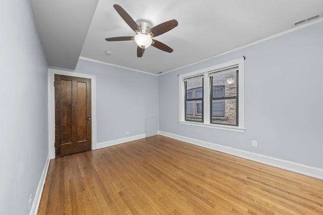 spare room with light hardwood / wood-style flooring, ceiling fan, and crown molding