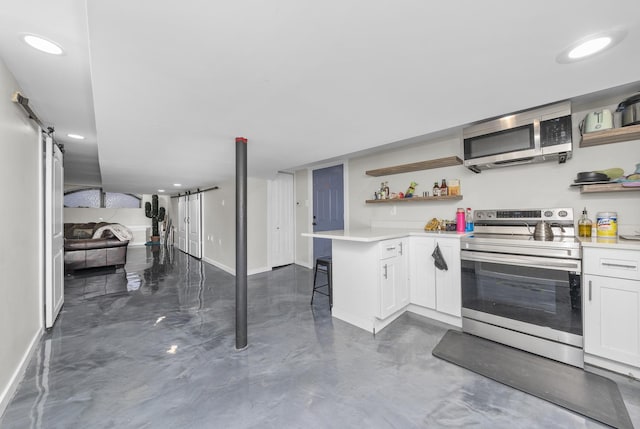 kitchen with a kitchen breakfast bar, white cabinetry, kitchen peninsula, and stainless steel appliances