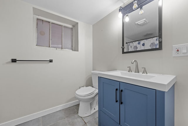 bathroom with tile patterned flooring, vanity, and toilet