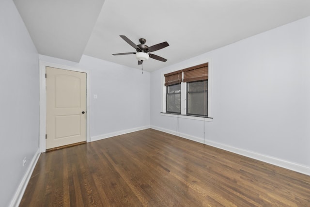 empty room featuring ceiling fan and dark hardwood / wood-style flooring