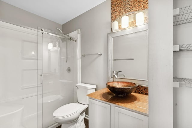 bathroom featuring vanity, toilet, and walk in shower