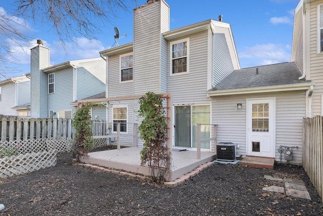 rear view of house featuring central AC and a deck