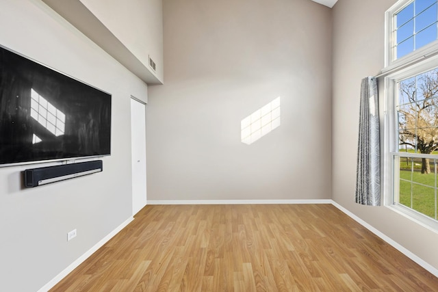 unfurnished room with light wood-type flooring