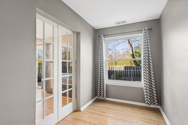 doorway to outside with french doors and light hardwood / wood-style flooring